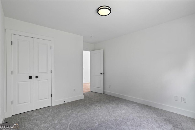 unfurnished bedroom with a closet and carpet