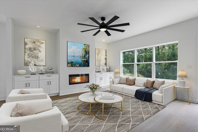 living room featuring hardwood / wood-style floors and ceiling fan