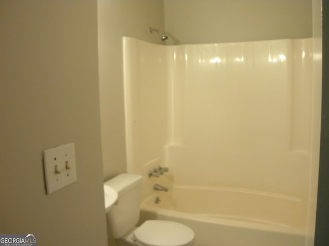 bathroom featuring toilet and  shower combination