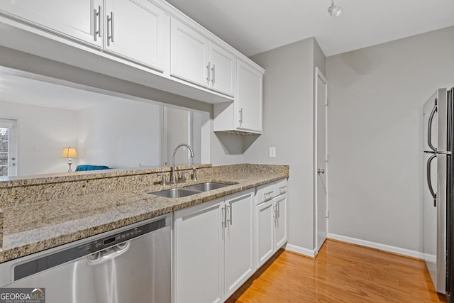 kitchen with white cabinetry, sink, stainless steel appliances, and light wood-type flooring