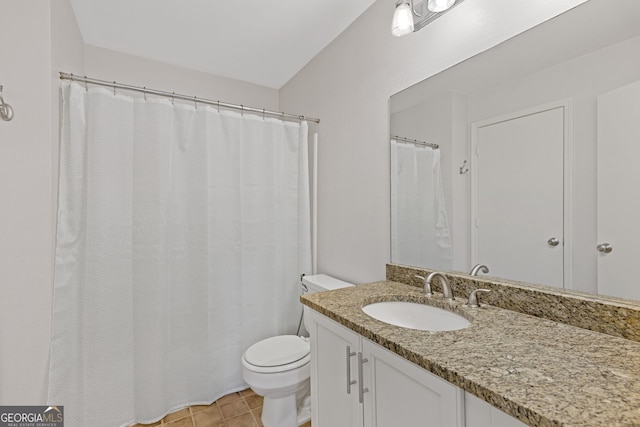 bathroom with tile patterned floors, vanity, and toilet