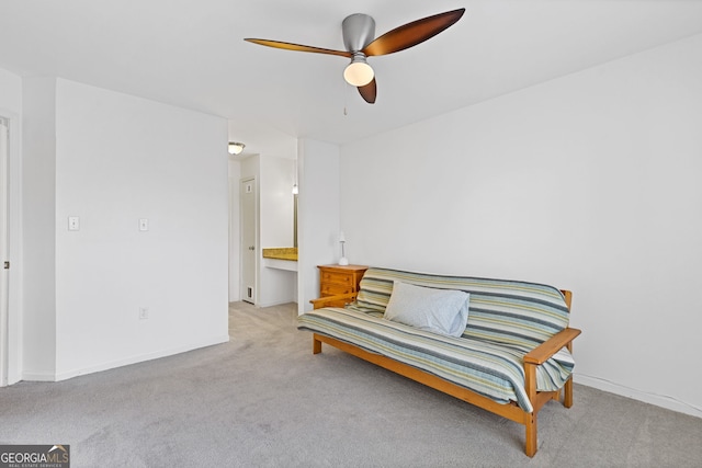 living area featuring light carpet and ceiling fan