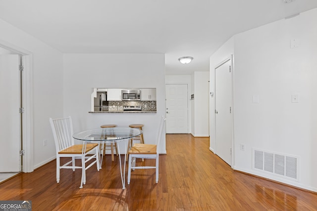 dining area with light wood-type flooring