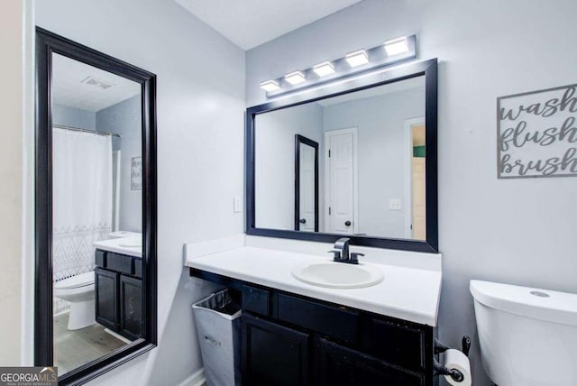 bathroom featuring vanity and toilet