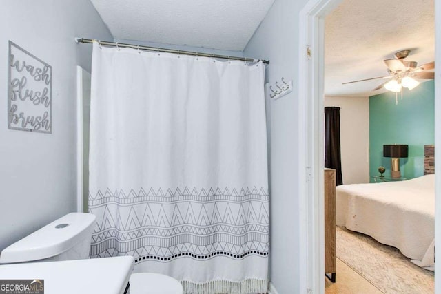 bathroom featuring ceiling fan, a textured ceiling, and toilet