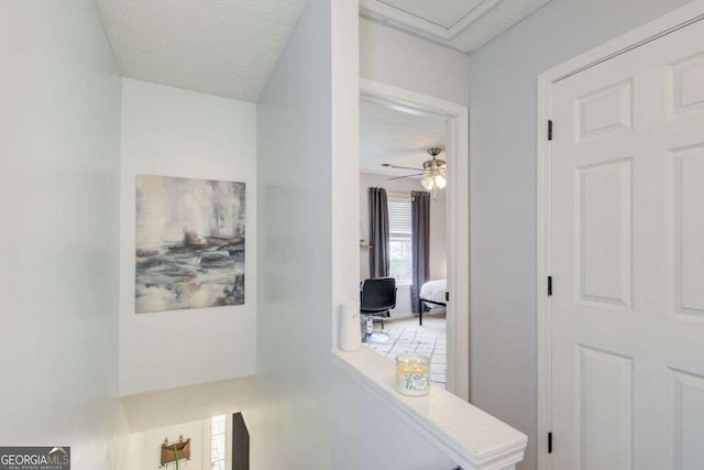 hallway with a textured ceiling