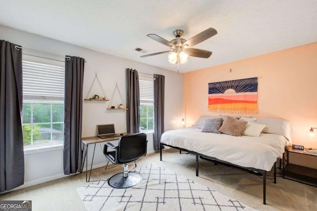 bedroom featuring ceiling fan and light carpet