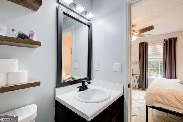 bathroom featuring vanity, ceiling fan, and toilet