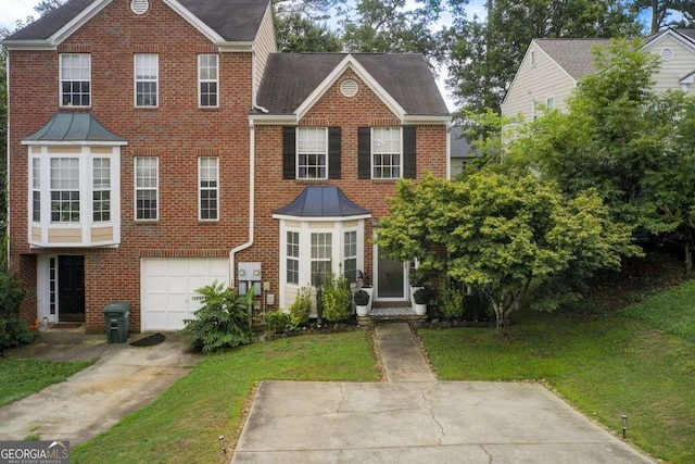 view of front of home featuring a front yard and a garage