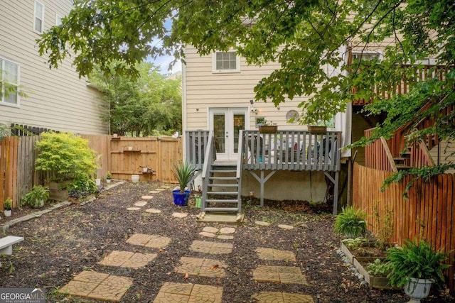 rear view of house featuring a deck and french doors