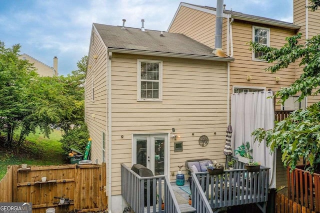 rear view of property with french doors and a wooden deck