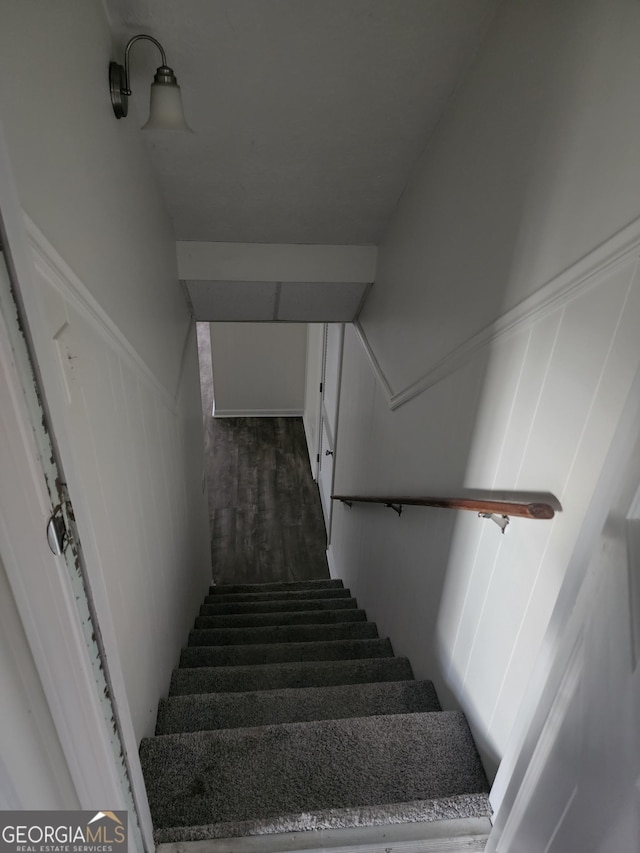 stairs featuring hardwood / wood-style floors