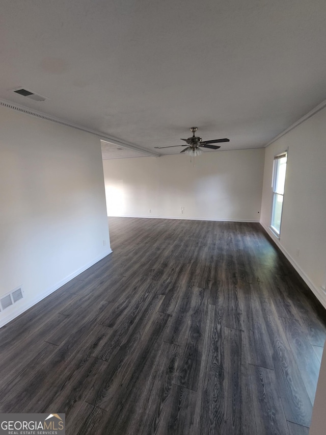 spare room featuring ceiling fan and dark hardwood / wood-style flooring