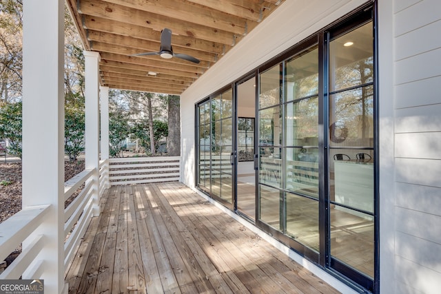 wooden terrace featuring ceiling fan and covered porch