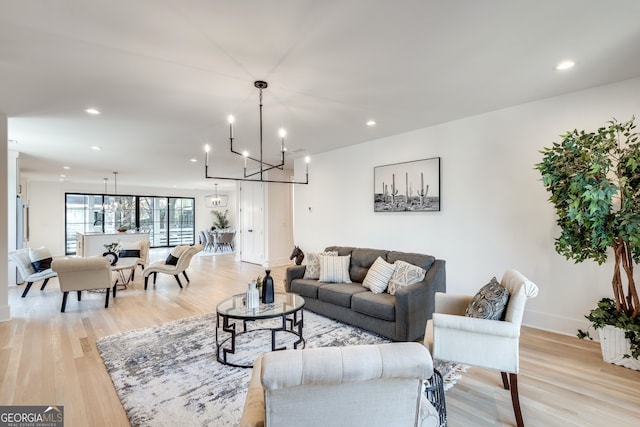 living room featuring light hardwood / wood-style floors and an inviting chandelier