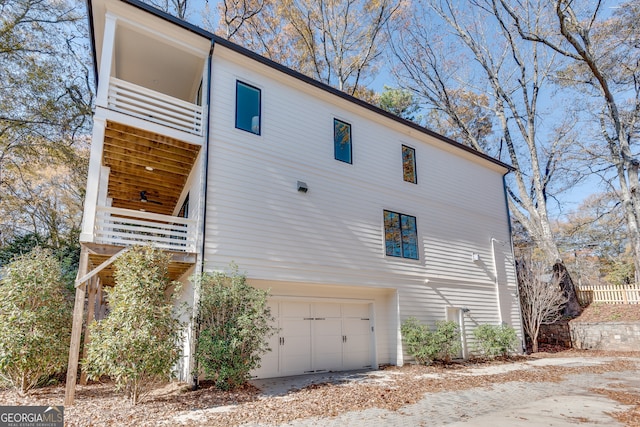 exterior space featuring a balcony and a garage