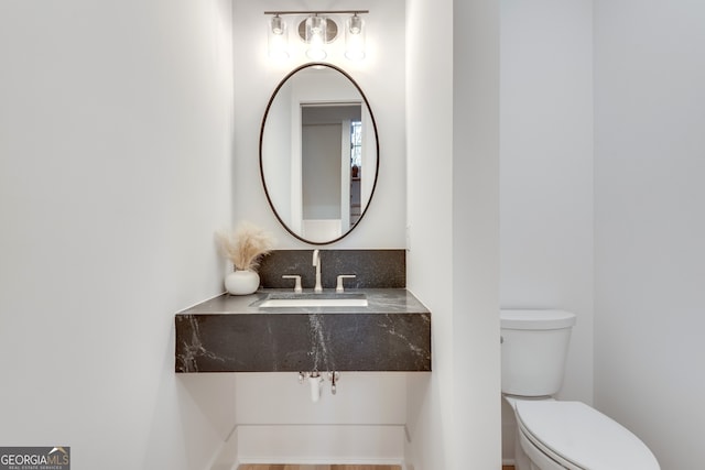 bathroom featuring toilet and sink