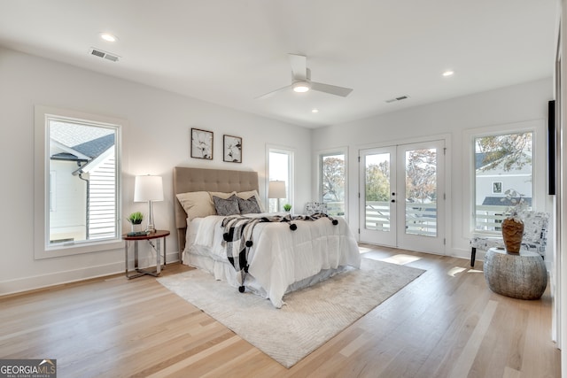 bedroom featuring access to outside, ceiling fan, french doors, and light wood-type flooring