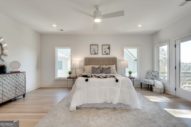 bedroom featuring access to exterior, light wood-type flooring, and ceiling fan