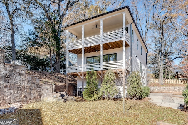 view of front of home featuring ceiling fan and a balcony