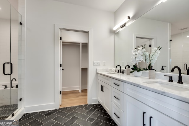 bathroom with vanity, wood-type flooring, and walk in shower