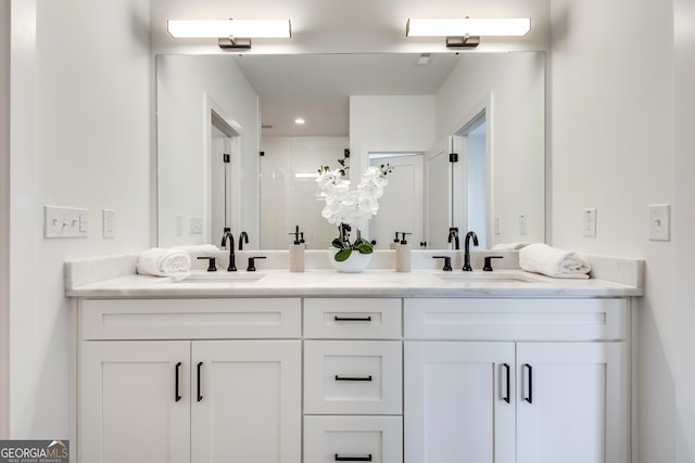 bathroom featuring vanity and an enclosed shower