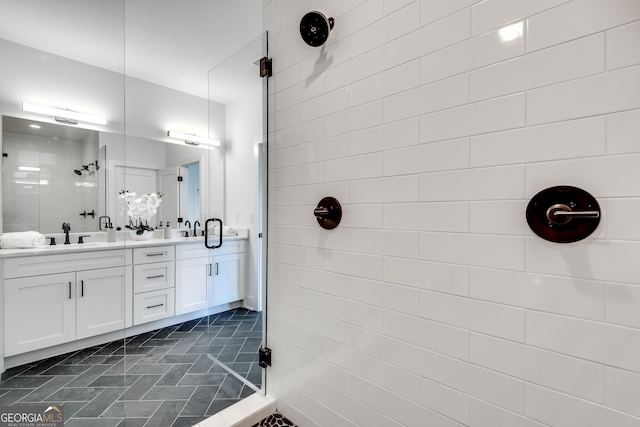 bathroom featuring vanity and a shower with door