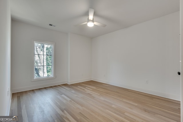 empty room featuring light hardwood / wood-style flooring and ceiling fan