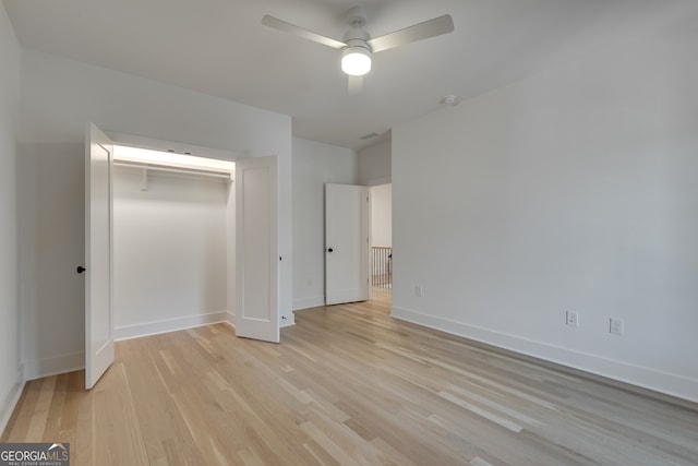 unfurnished bedroom with ceiling fan, a closet, and light hardwood / wood-style floors