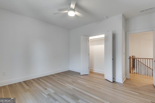 unfurnished bedroom with ceiling fan, light hardwood / wood-style floors, and a closet