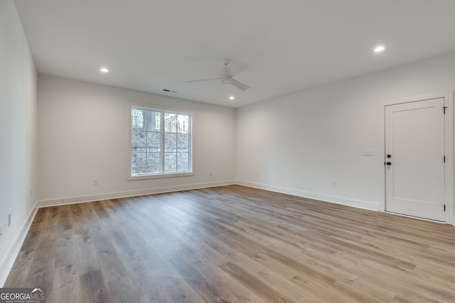 empty room featuring ceiling fan and light hardwood / wood-style floors