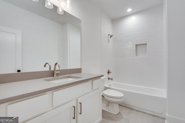 full bathroom with toilet, tile patterned flooring, vanity, and tiled shower / bath