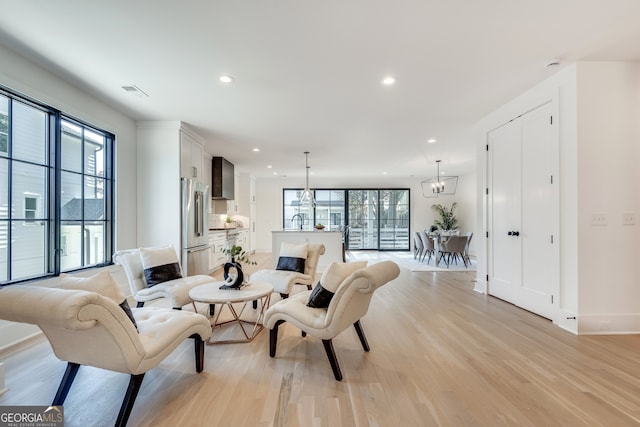 living room with plenty of natural light and light hardwood / wood-style floors