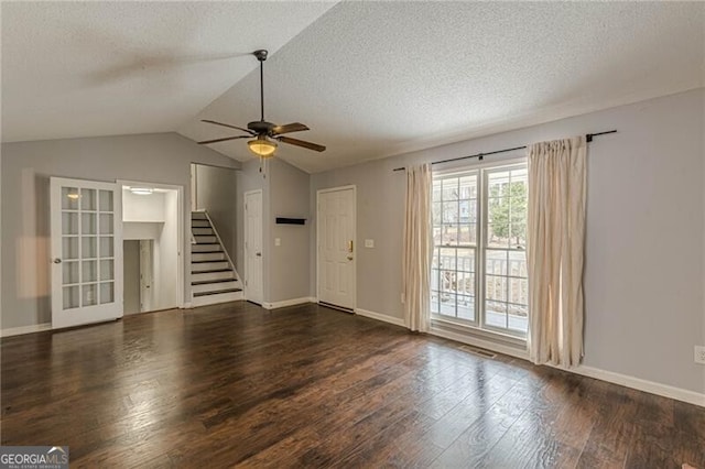 unfurnished living room featuring a textured ceiling, dark hardwood / wood-style flooring, vaulted ceiling, and ceiling fan