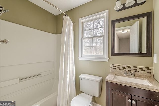 full bathroom with vanity, tasteful backsplash, toilet, and shower / bath combo with shower curtain