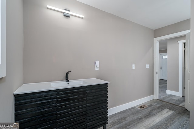 bathroom with vanity and hardwood / wood-style flooring