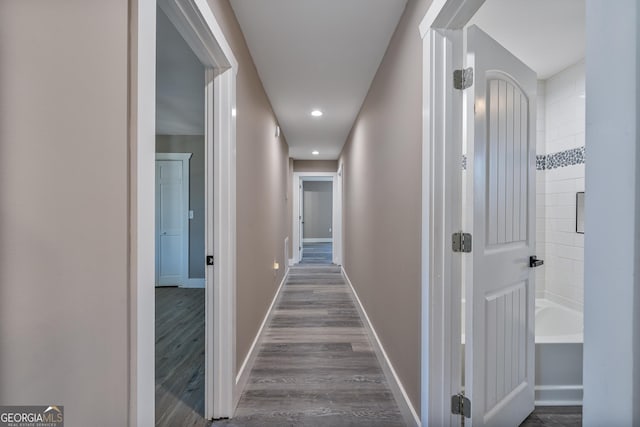 hallway with wood-type flooring