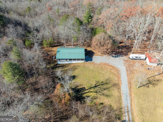 birds eye view of property with a wooded view