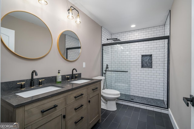 bathroom with tile patterned floors, vanity, toilet, and a shower with shower door