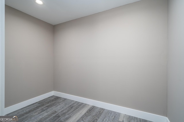 unfurnished room with baseboards, wood finished floors, and recessed lighting