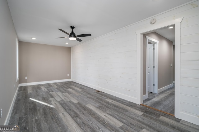 unfurnished room with ceiling fan and dark wood-type flooring