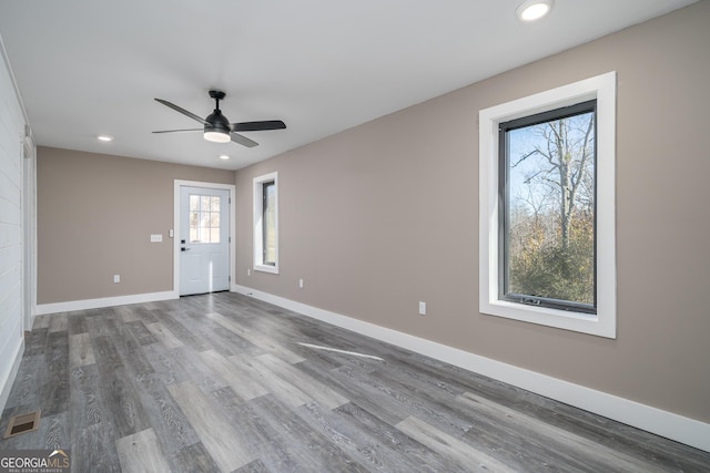 empty room with wood-type flooring and ceiling fan