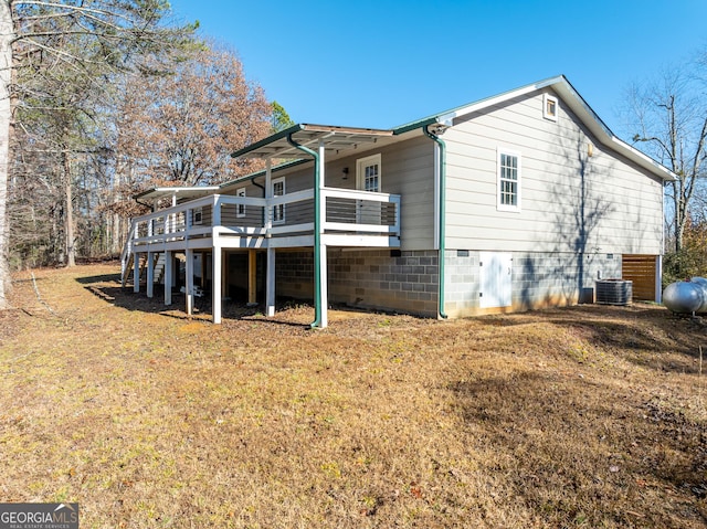 view of side of home with a lawn and a wooden deck