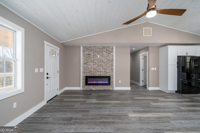 unfurnished living room with vaulted ceiling, a brick fireplace, ceiling fan, dark hardwood / wood-style flooring, and wood ceiling