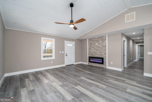 unfurnished living room featuring hardwood / wood-style floors, lofted ceiling, wooden ceiling, ceiling fan, and a fireplace