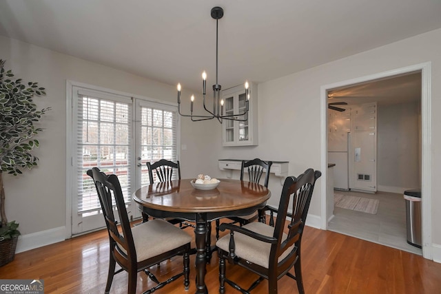 dining room featuring a notable chandelier and light hardwood / wood-style flooring