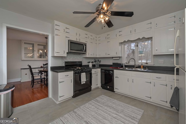 kitchen with white cabinetry, sink, ceiling fan, and black appliances