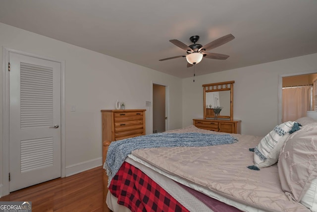 bedroom with a closet, light hardwood / wood-style flooring, and ceiling fan