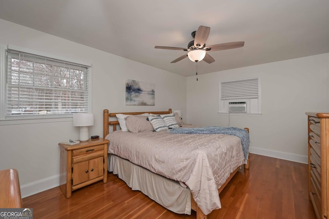 bedroom with hardwood / wood-style floors, ceiling fan, and cooling unit