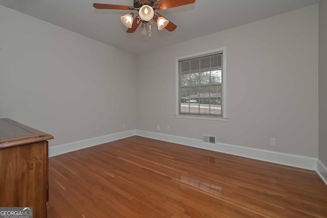 empty room with ceiling fan and wood-type flooring